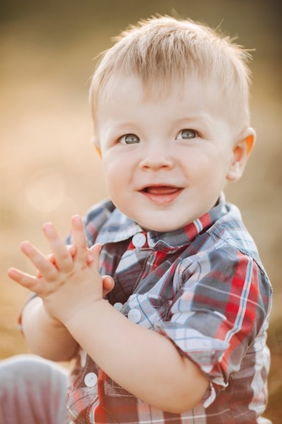 portrait-happy-boy-sitting-clapping-hands-while-enjoying-holiday-outdoors_132075-5818.jpg