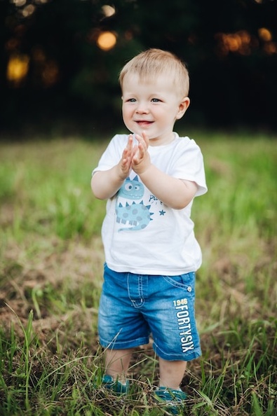 stock-photo-portrait-t-shirt-denim-shorts-clapping-hands-smiling-standing-green-lawn-park-bokeh-background-cheerful-baby-boy-standing-grass-with-hands-clapping_132075-10366.jpg