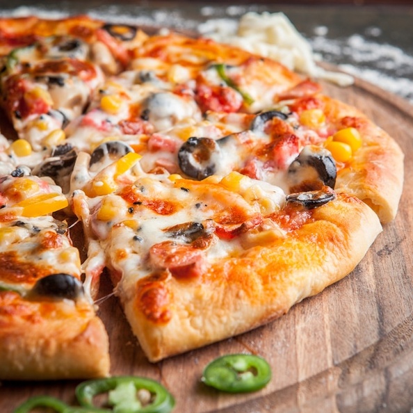 side-view-pizza-with-chopped-pepper-board-cookware_176474-3183.jpg