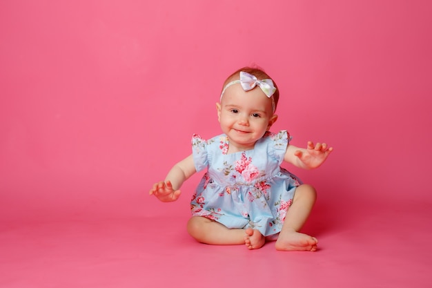 baby-girl-portrait-dressed-dress-sitting-pink-background_106368-2608.jpg