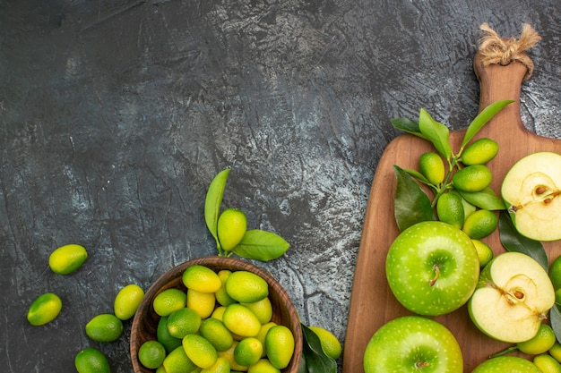 top-close-up-view-apples-bowl-citrus-fruits-green-apples-with-leaves-board_140725-78535.jpg