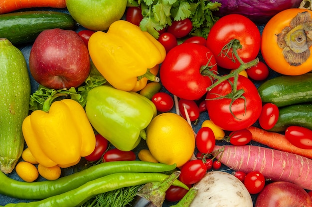 top-view-fruits-vegetables-bell-peppers-apples-carrot-coriander-cauliflower-persimmon-radish-cherry-tomatoes-red-cabbage-tomatoes-green-hot-pepper_140725-145407.jpg
